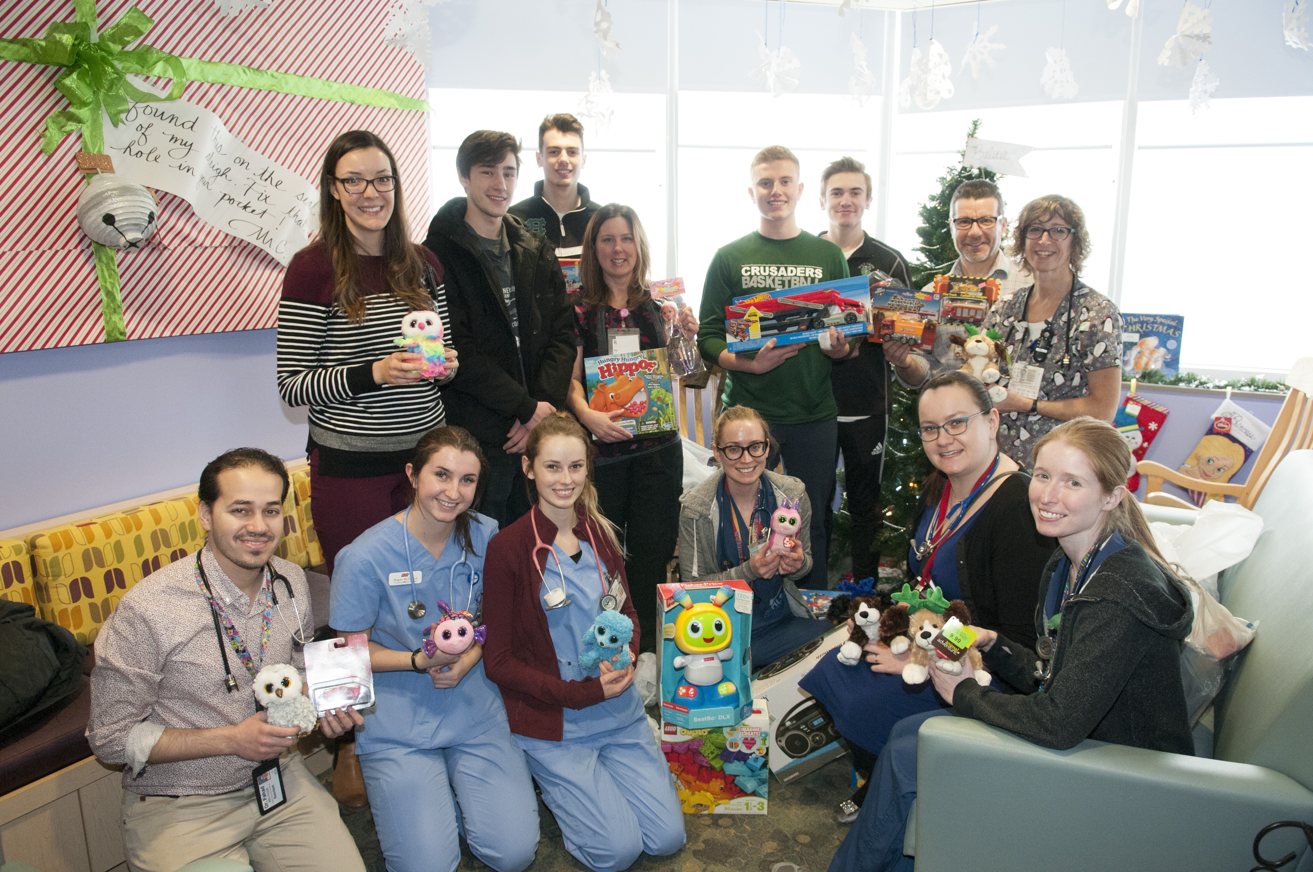 Members of the Holy Cross senior boys basketball team donate toys to pediatric patients this Christmas