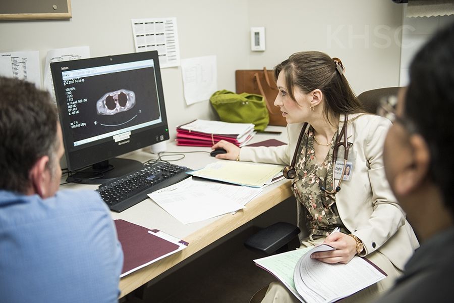 Dr. Genèvieve Digby meets with a team to discuss a care plan for a patient visiting the clinic immediately after being diagnosed with lung cancer