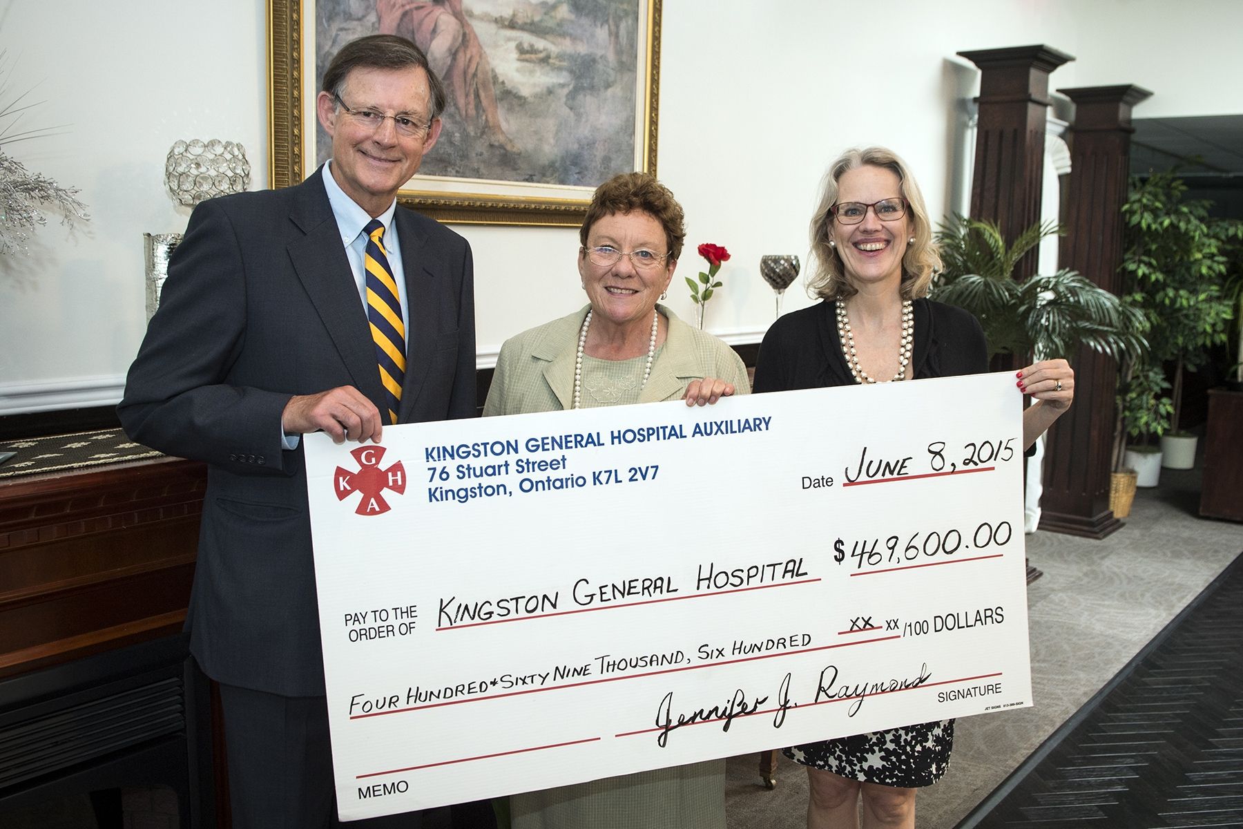 Auxiliary President Jenny Raymond (centre) hands a cheque worth just under $470,000 to KGH Board Chair Scott Carson and CEO Leslee Thompson. 