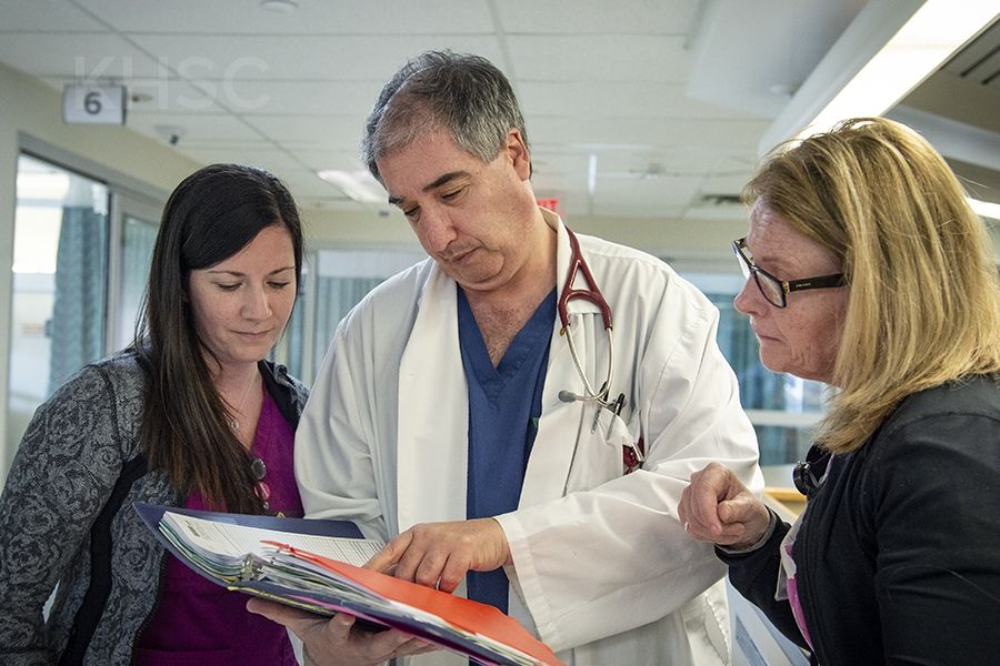 Dr. Baranchuk (centre) reviews the tool with nurses in KHSC's cardiac sciences unit