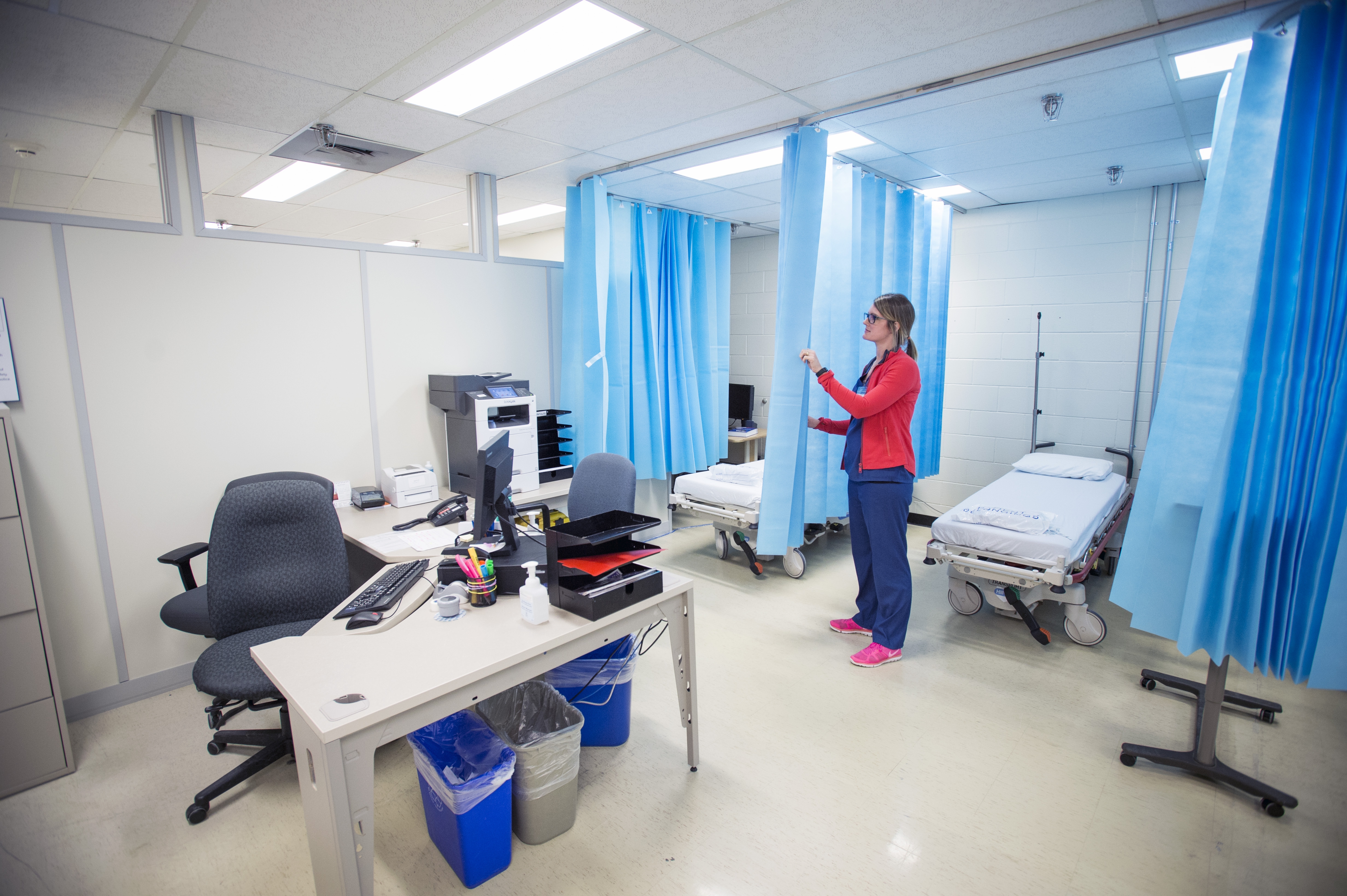 Jessa Rego, RN, prepares two of the six stations for patients.