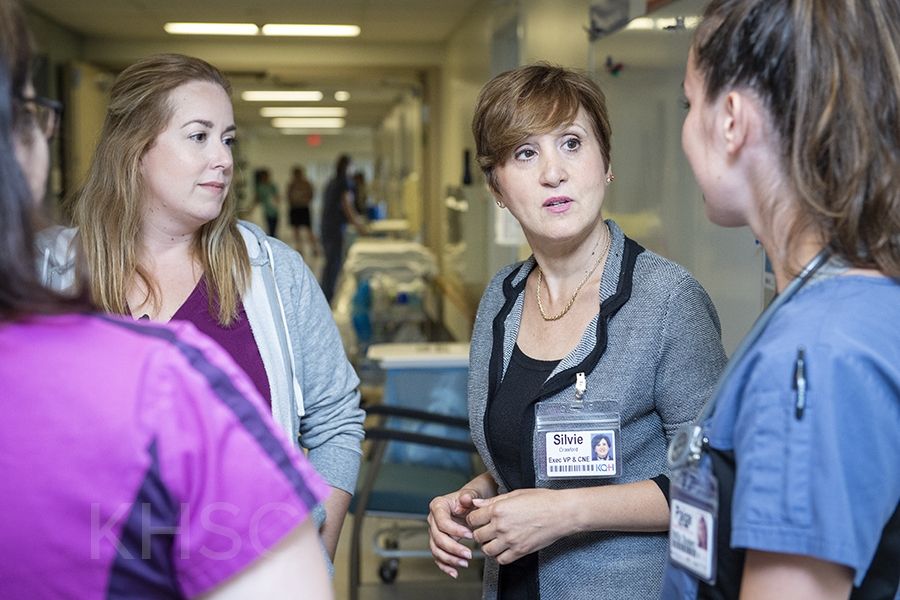 Registered nurses Erin Lowry and Morag Mercer, and nursing student Paige Blanchard on Kidd 6 gather with Silvie Crawford, Executive Vice-president and Chief Nursing Executive of Patient Care Programs at KHSC to discuss what it means to be designated a Best Practice Spotlight Organization. Kidd 6 will be the first team to implement best practice guidelines related to the designation –- starting in Oct. with guidelines for preventing falls and dealing with pressure injuries.