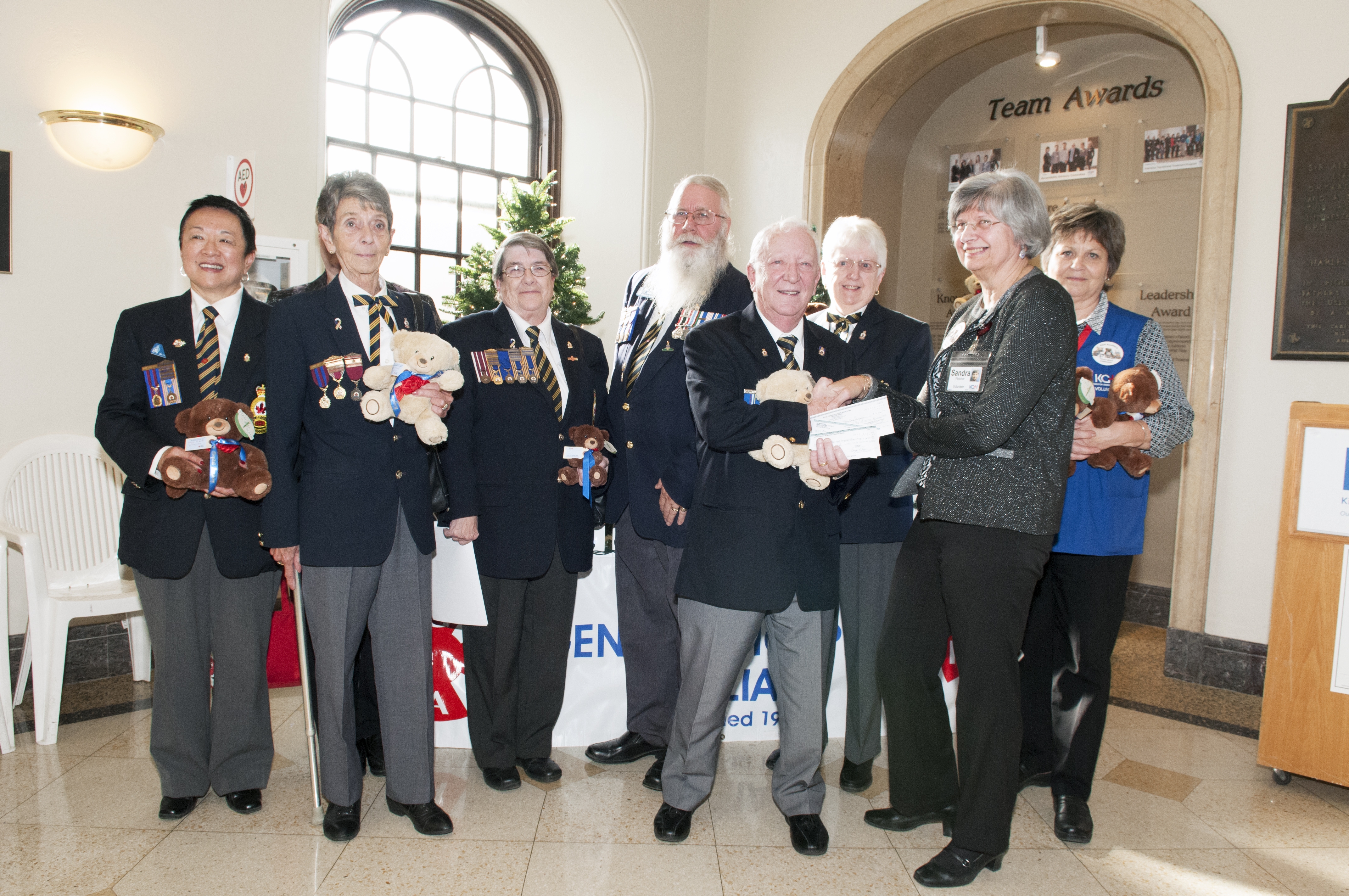 Members of the Royal Canadian Legion present their cheques as financial sponsors to members of the KGH Auxiliary